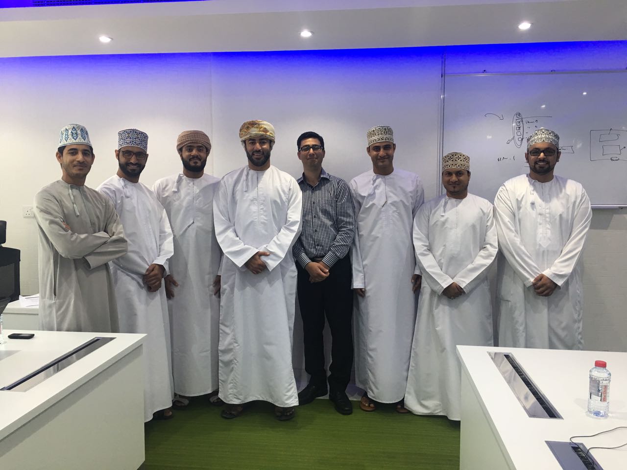 SBEEH Software Academy — Two participants each receiving a Certificate of Achievement alongside the trainer